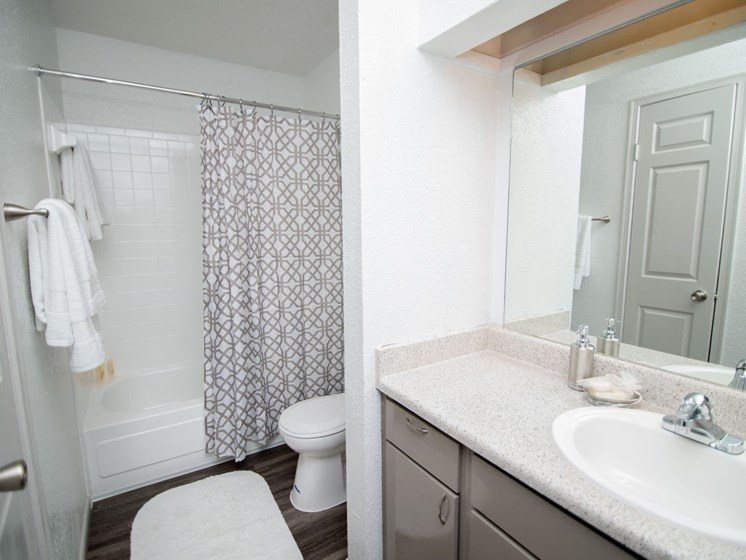 View of bathroom with full-size, vanity mirror.